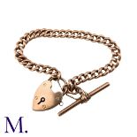 A Gold Curb Bracelet in 9K rose gold with padlock clasp and T-bar. Padlock stamped 9ct and links