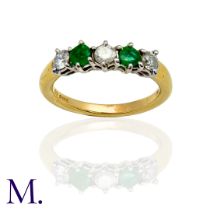 An Emerald and Diamond 5-Stone Ring in 18K yellow and white gold, set with three round cut