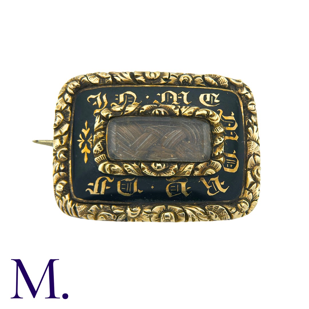 A Regency Hairwork Mourning Brooch in yellow gold. Black enamel work to the front with words 'in