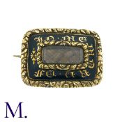 A Regency Hairwork Mourning Brooch in yellow gold. Black enamel work to the front with words 'in