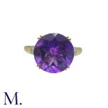 An Amethyst And Diamond Ring in 14k yellow gold, set with a principal round cut amethyst of