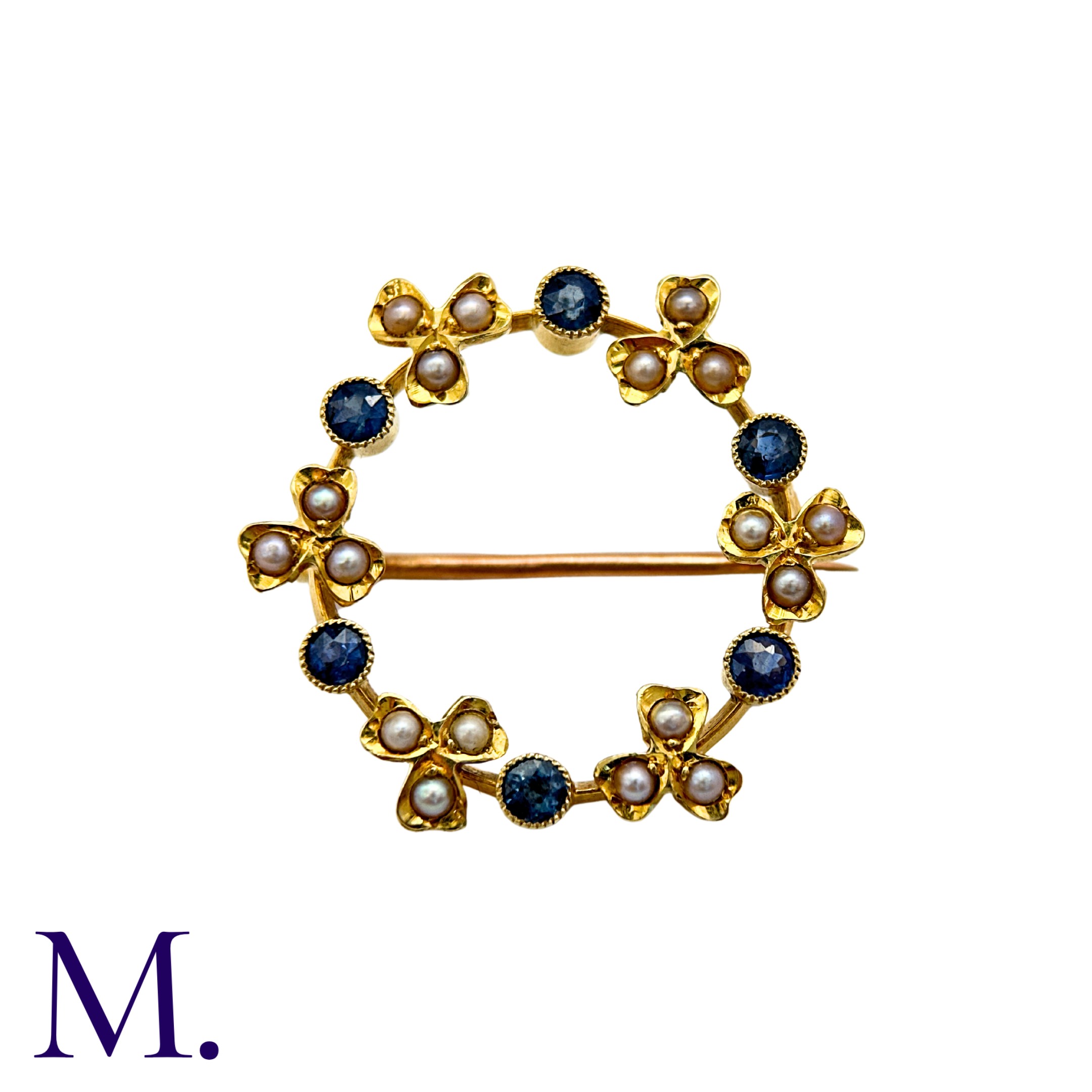 A Pearl And Sapphire Brooch in 15k yellow gold, the circular, foliate form set with round cut