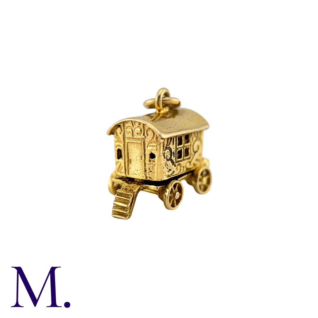 A Group of Gold Charms including a wagon, a camel, a handbag, a water carrier, a boot and a cross. - Image 2 of 7