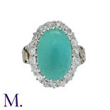 An Antique Turquoise and Diamond Cluster Ring in 18K yellow gold, set with an oval cabochon of