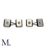 A Pair of Onyx And Diamond Cufflinks in platinum, each set with a diamond weighing approximately 0.