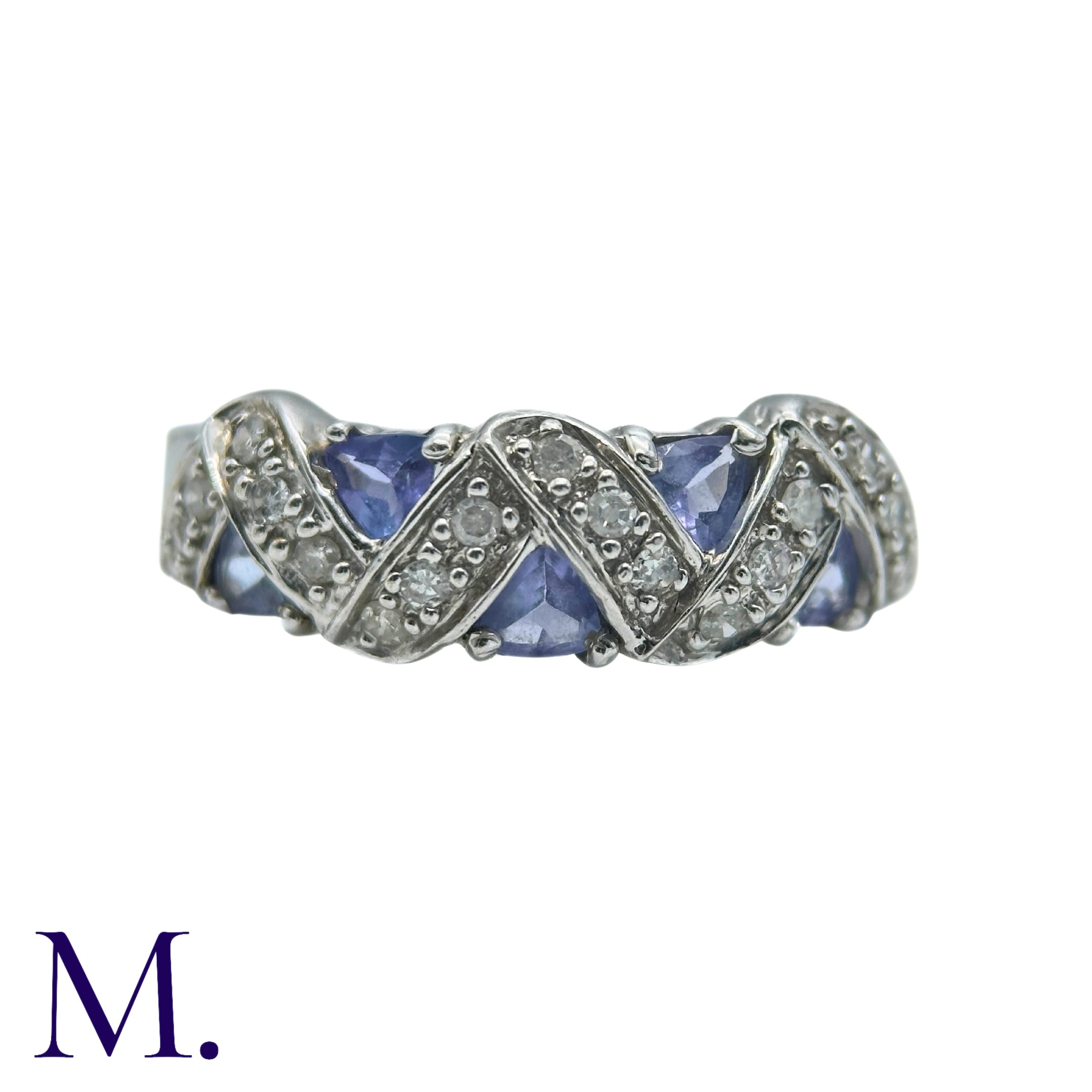 A Tanzanite And Diamond Ring in 9k white gold, set with trillion cut tanzanites and round cut
