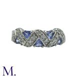 A Tanzanite And Diamond Ring in 9k white gold, set with trillion cut tanzanites and round cut