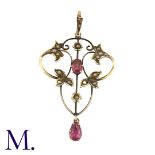 A Pink Stone and Pearl Pendant in 9K yellow gold, the openwork folate form set with an oval-cut pink