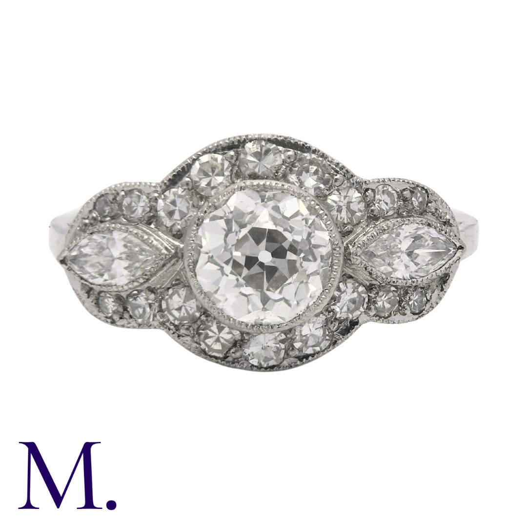 A Diamond Ring in white gold set with a principal diamond weighing approximately 0.90ct with two