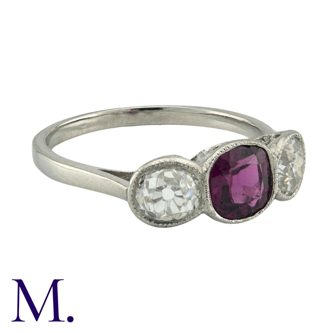A Ruby And Diamond Three Stone Ring in platinum, set with a principal cushion cut ruby of - Image 2 of 4