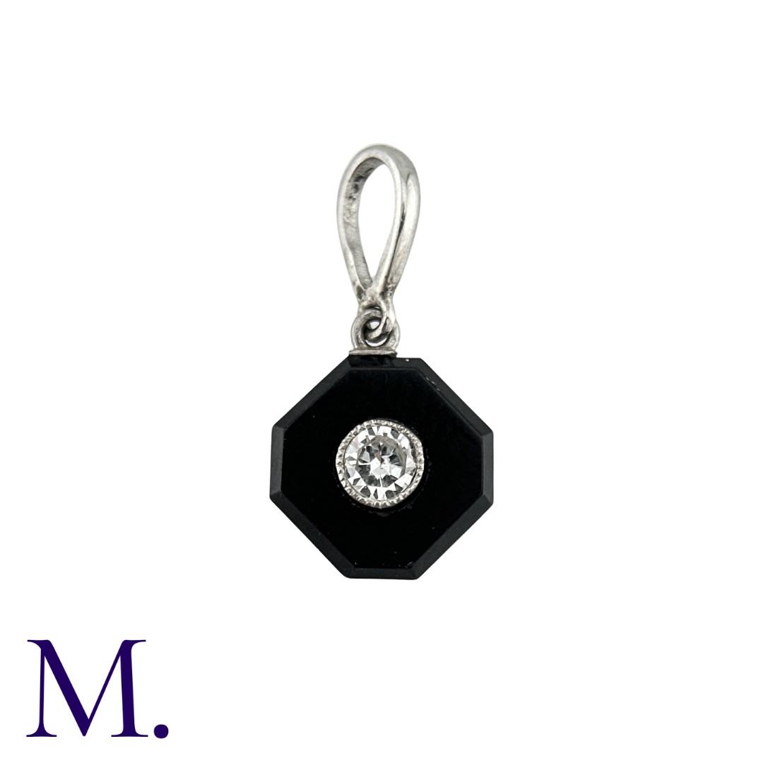 An Onyx And Diamond Pendant in platinum, comprising a polished octagonal plaque of onyx, inset