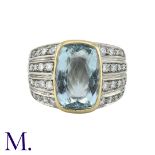 An Aquamarine And Diamond Ring in 18k white and yellow gold, set with a principal aquamarine of