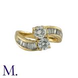 A Diamond Crossover Ring in 18K yellow gold, set with two round cut diamonds weighing