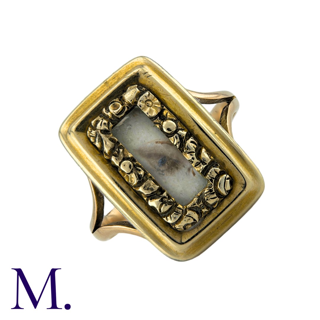 An Antique Lover's Eye Ring in 15k yellow gold, set with and ornate, foliate framed aperture