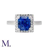 A Sapphire & Diamond Ring in 18K white gold, set with a faceted square cut sapphire (accompanied