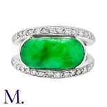 A Jade and Diamond Ring in 18K white gold, set with an oval panel of jade and round cut diamonds