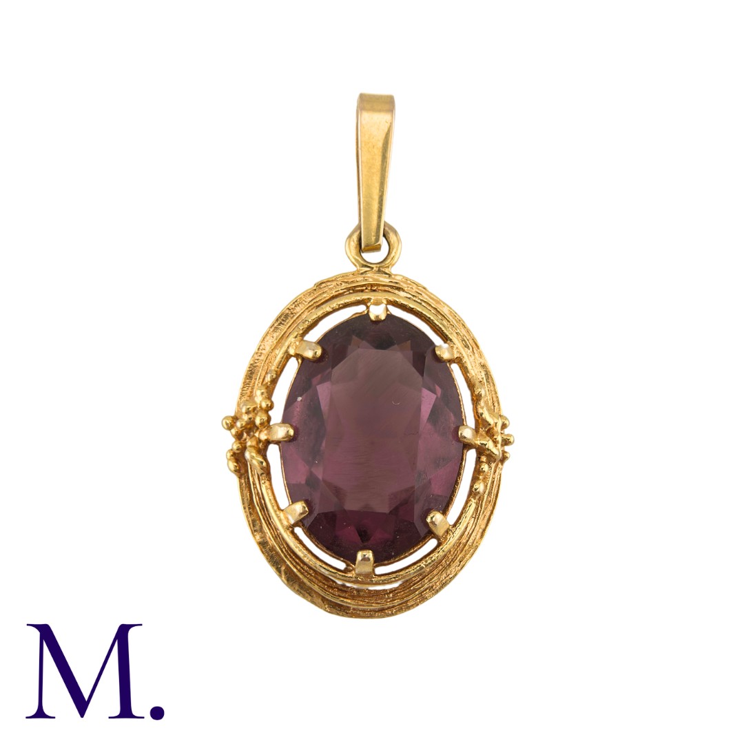 An Purple Stone Pendant in 9k yellow gold, comprising a large oval cut purple stone within a