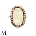 A Moonstone and Diamond Ring in 9K yellow gold, set with a large cabochon moonstone (18x11mm) with