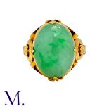 A Jade Ring in yellow gold, set with an oval jade cabochon. Band marked internally with Chinese