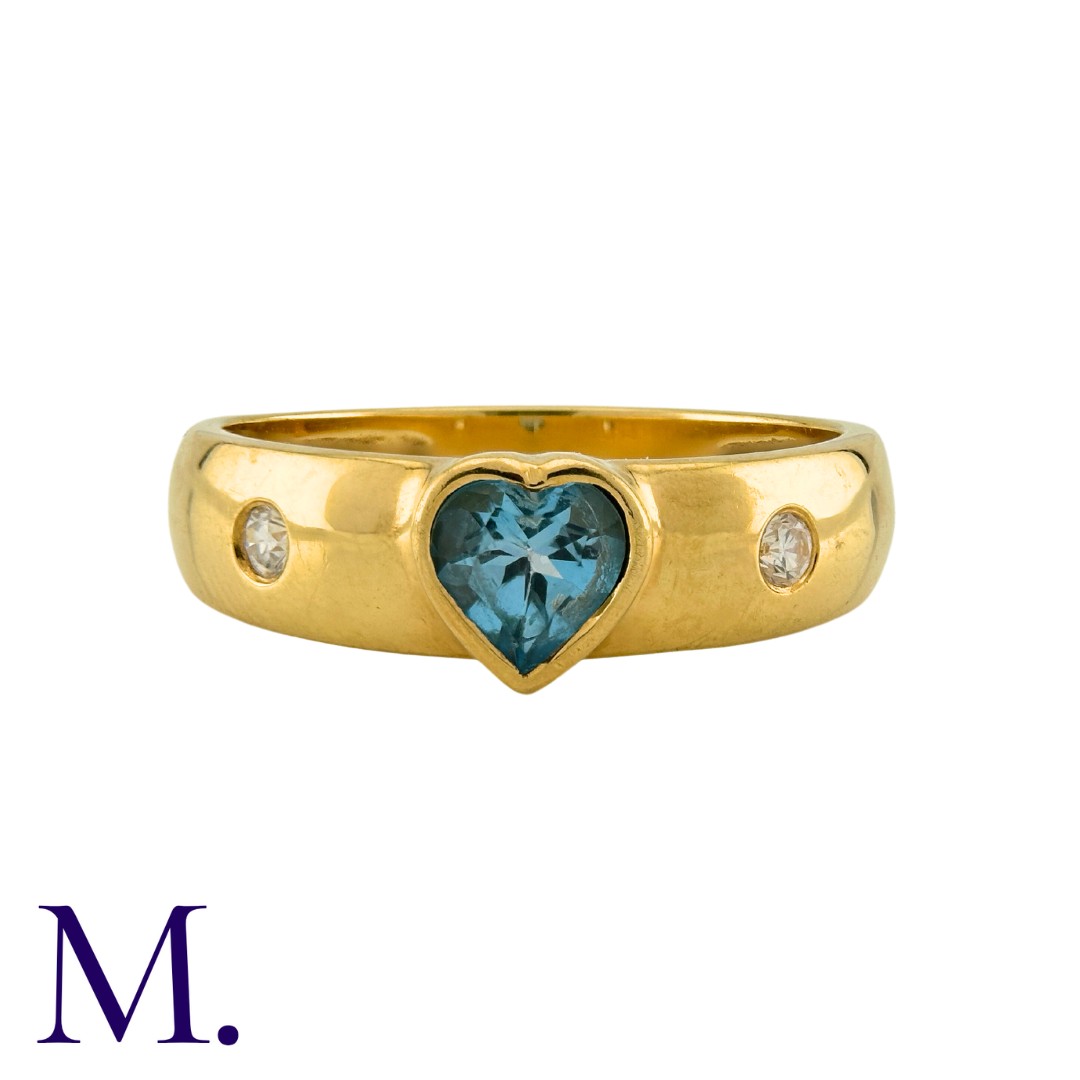 An Aquamarine and Diamond Ring in 18K yellow gold, set with a heart-cut aquamarine and flush set