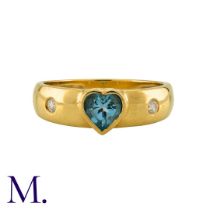 An Aquamarine and Diamond Ring in 18K yellow gold, set with a heart-cut aquamarine and flush set