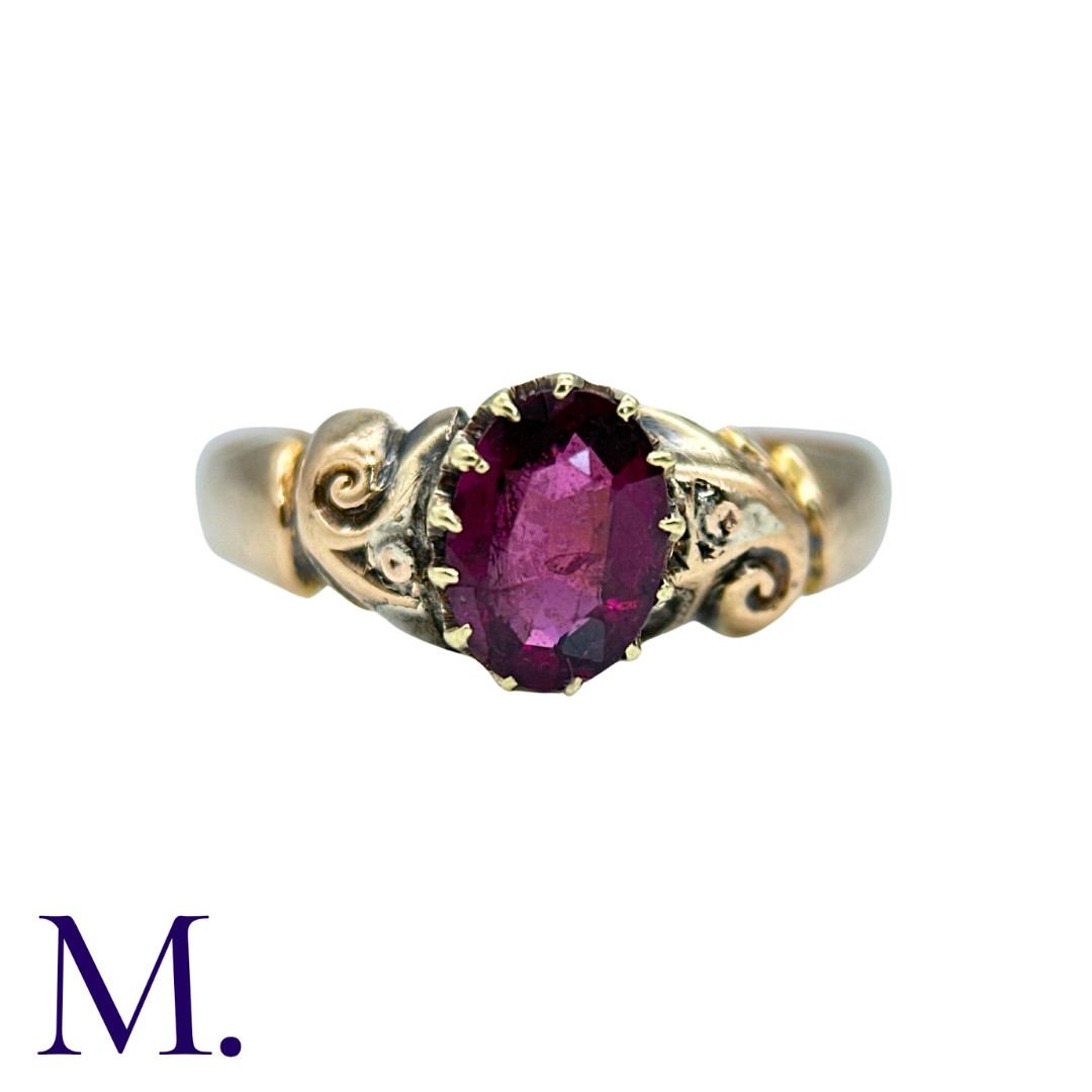 An Antique Garnet Ring in 18K set with an oval-cut garnet (approximately 7x5mm). Hallmarked for 18ct