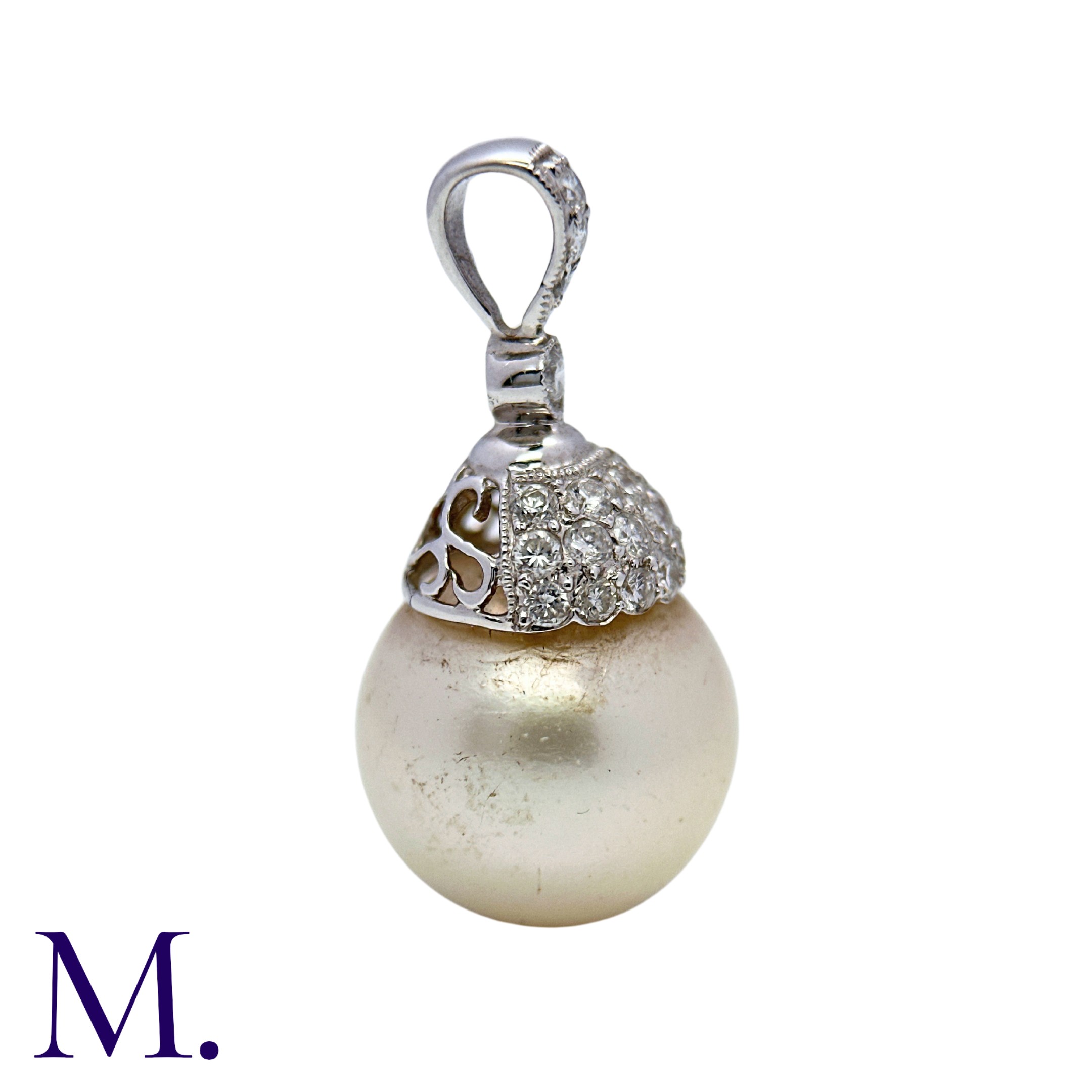 A Diamond and Pearl Drop Pendant in 18K white gold, set with a round cream pearl of approximately