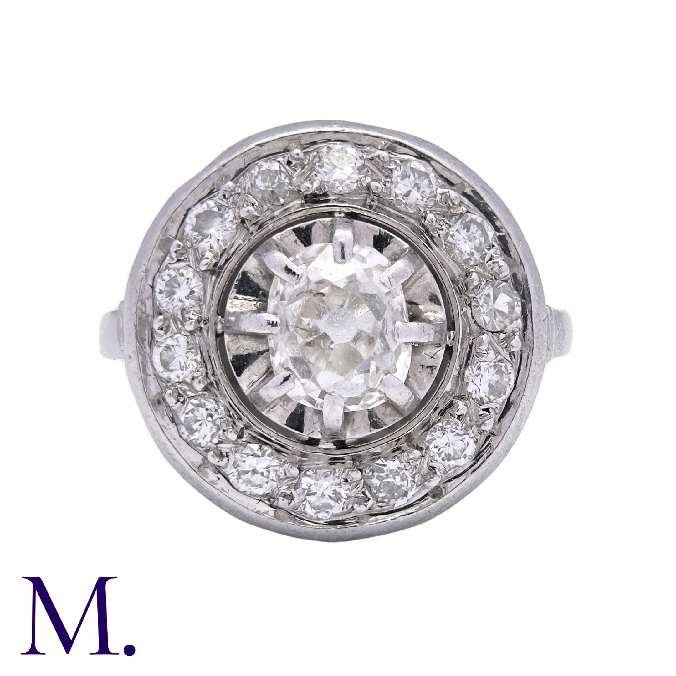 A Diamond Cluster Ring in 18K white gold set with an old cut diamond to the centre with fourteen