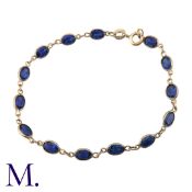 A Sapphire Bracelet in 9K yellow gold, with 14 spectacle-set oval-cut sapphires, each sapphire