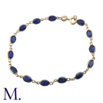A Sapphire Bracelet in 9K yellow gold, with 14 spectacle-set oval-cut sapphires, each sapphire