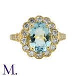 An Aquamarine And Diamond Cluster Ring in yellow gold, set with a central oval cut aquamarine of