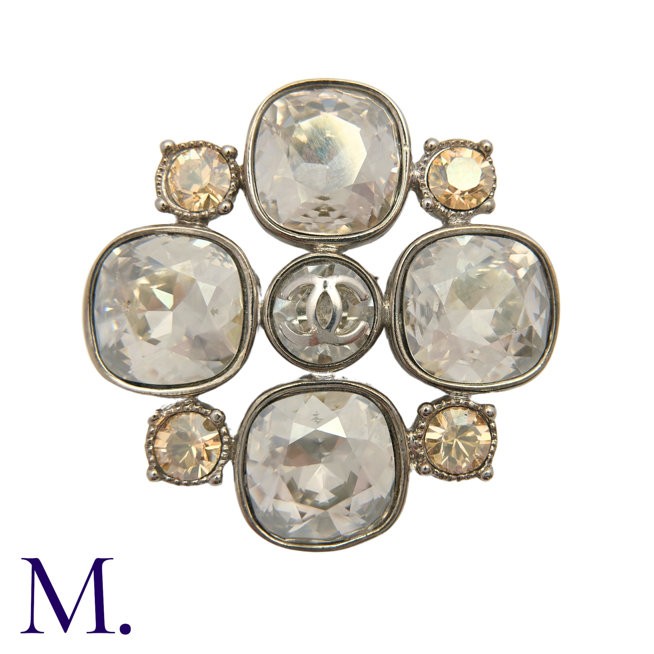 CHANEL. A Costume Brooch in quatrefoil form, set with large light lilac stones to the cardinal