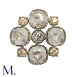 CHANEL. A Costume Brooch in quatrefoil form, set with large light lilac stones to the cardinal