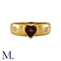 A Garnet and Diamond Ring in 18K yellow gold, with a heart-shaped Garnet and flush set diamonds.