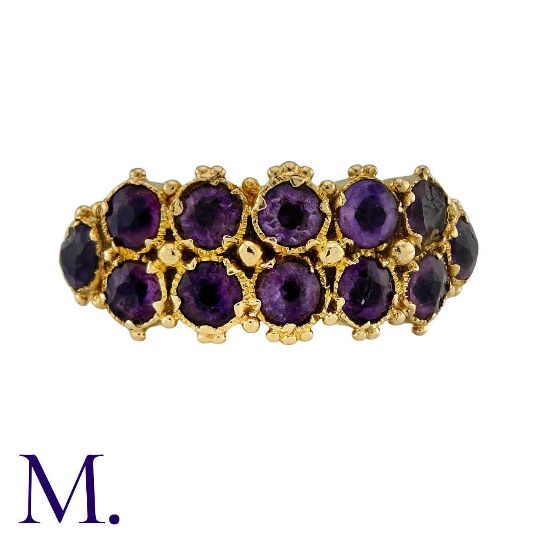 A Two-Row Amethyst Ring in yellow gold, set with twelve amethysts in two rows to an engraved band.