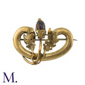 An Antique Garnet Brooch in 9K yellow gold. Set with a cabochon garnet as an acorn between two oak