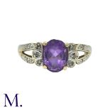 An Amethyst And Diamond Ring in 9k yellow gold, set with a central oval cut amethyst, accented by