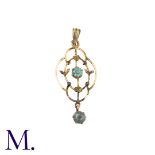 A Blue Stone Pendant in 9k yellow gold, the open work foliate and scrolling form set with a round