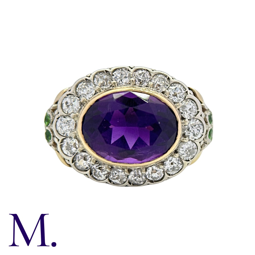 An Amethyst and Diamond Cluster Ring in yellow gold and silver, set with a principal oval cut