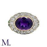 An Amethyst and Diamond Cluster Ring in yellow gold and silver, set with a principal oval cut