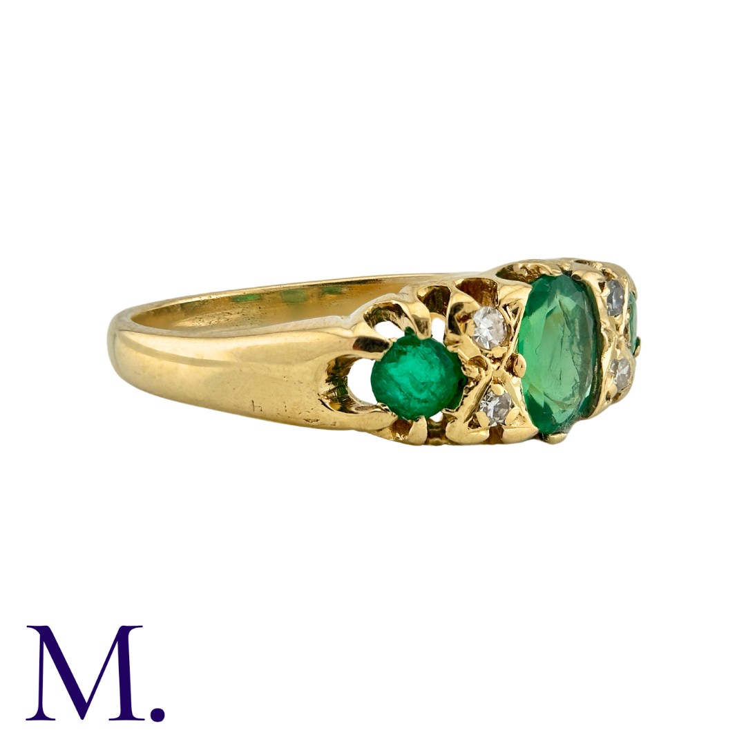 An Emerald And Diamond Ring in 18k yellow gold, set with a principal oval cut emerald, and two round - Image 2 of 3