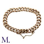 A Gold Curb Bracelet in 9K rose gold, with integrated fastening and safety chain. Size: 21cm Weight: