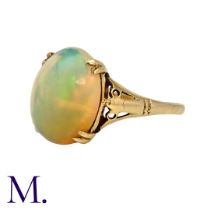 An Opal Ring in 9k yellow gold, set with a central cabochon opal of approximately 3.50cts. Stamped