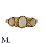 An Opal and Diamond Ring in 18K yellow gold, set with three oval cabochon opals with four round