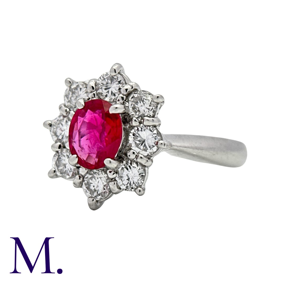 A Ruby & Diamond Cluster Ring in platinum, set with an oval cut ruby of approximately 0.65ct and - Bild 2 aus 2