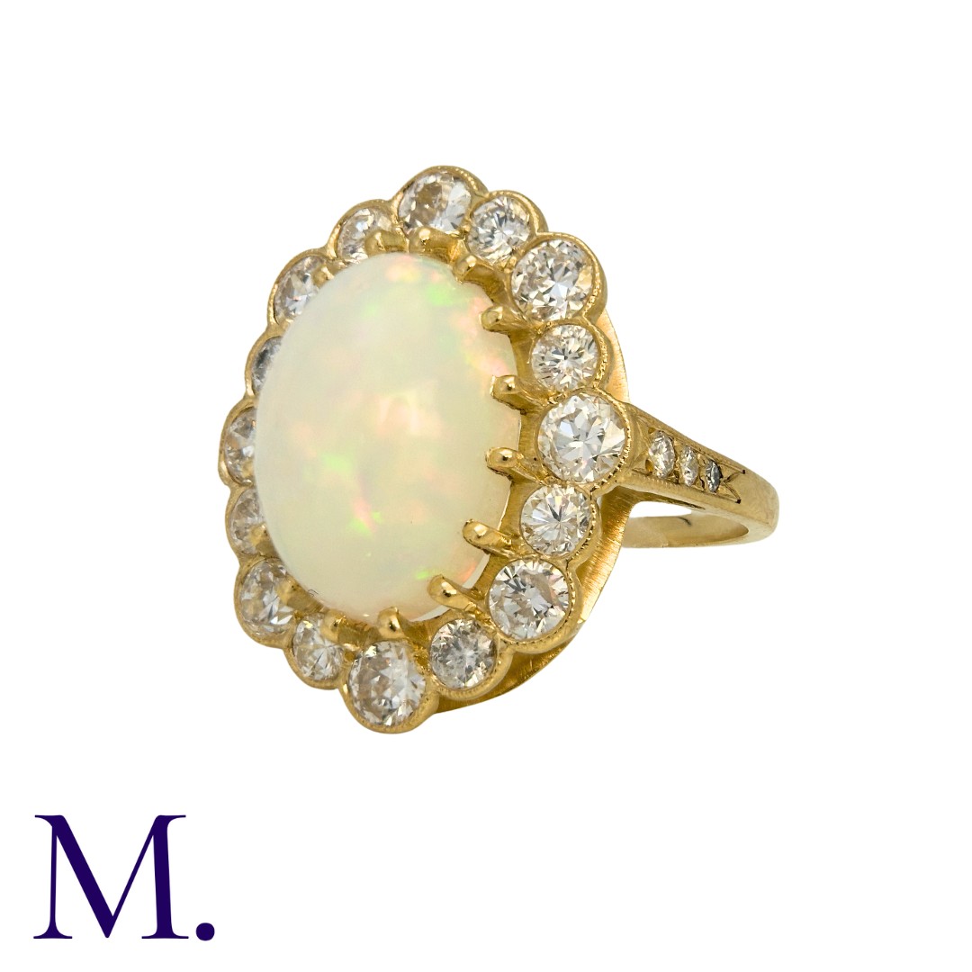 An Opal And Diamond Cluster Ring in 18k yellow gold, set with a principal cabochon opal of - Image 2 of 5