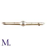 A Diamond Bar Brooch in yellow gold and platinum, set with a round cut diamond weighing