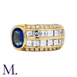 A Sapphire and Diamond Ring in 18K yellow gold, offset with an oval-cut sapphire with princess and