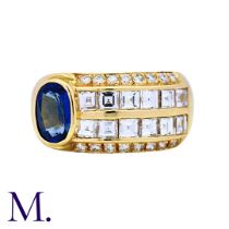 A Sapphire and Diamond Ring in 18K yellow gold, offset with an oval-cut sapphire with princess and
