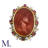 An Antique Carnelian, Ruby And Enamel Cameo Brooch in yellow gold, the carved carnelian cameo